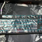 Epic hand-sculpted Attack on Titan keycap set showcasing a backlit beast-form sculpture with translucent, glowing details, a premium artisan collectible.