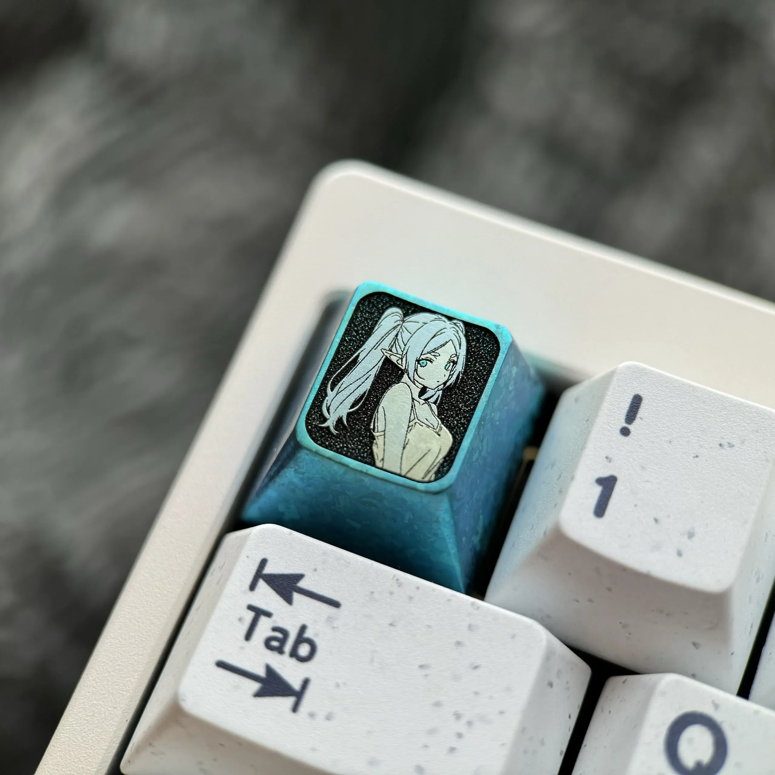 A gallery of Frieren Titanium Keycaps, spotlighting the premium titanium alloy and ethereal ice crystal blue. Various angles emphasize its characteristic.