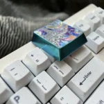 Multiple angles of the premium Anodized Mobile Suit Gundam Titanium Keycap. Its bold, futuristic mecha design and vibrant metallic sheen highlight the durable touch.