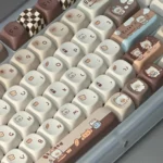 A delightful gallery showcasing Adorable Siamese Cat Bakery Keycaps, featuring round pastel-hued designs with whimsical cats and sweet treats.