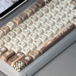 Whimsical Adorable Siamese cat bakery keycaps set, featuring charming cat and pastry designs on round, pastel MOA profile keys for ergonomic comfort.