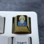 A premium Alice Zuberg Inspired Titanium ESC Keycap gleams with a luxurious ice crystal gold finish, featuring its enchanting custom design for mechanical keyboard.