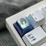 Gallery showcasing the premium titanium alloy Rio Tsukatsuki anime ESC keycap, with vibrant sculpted art details from multiple angles.