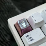 Sumireko Sanshokuin Anime Titanium Keycap. Exclusive ice crystal purple, vibrant character art. Premium metal art showcased from angles.