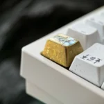Gallery of the Valiant Sword Maiden anime titanium keycap, showcasing its premium colored titanium craftsmanship and vibrant icy crystal motif.
