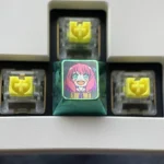 Vibrant Anya Forger titanium alloy keycaps set, featuring artistic designs that capture iconic Spy x Family anime expressions on lustrous metal.