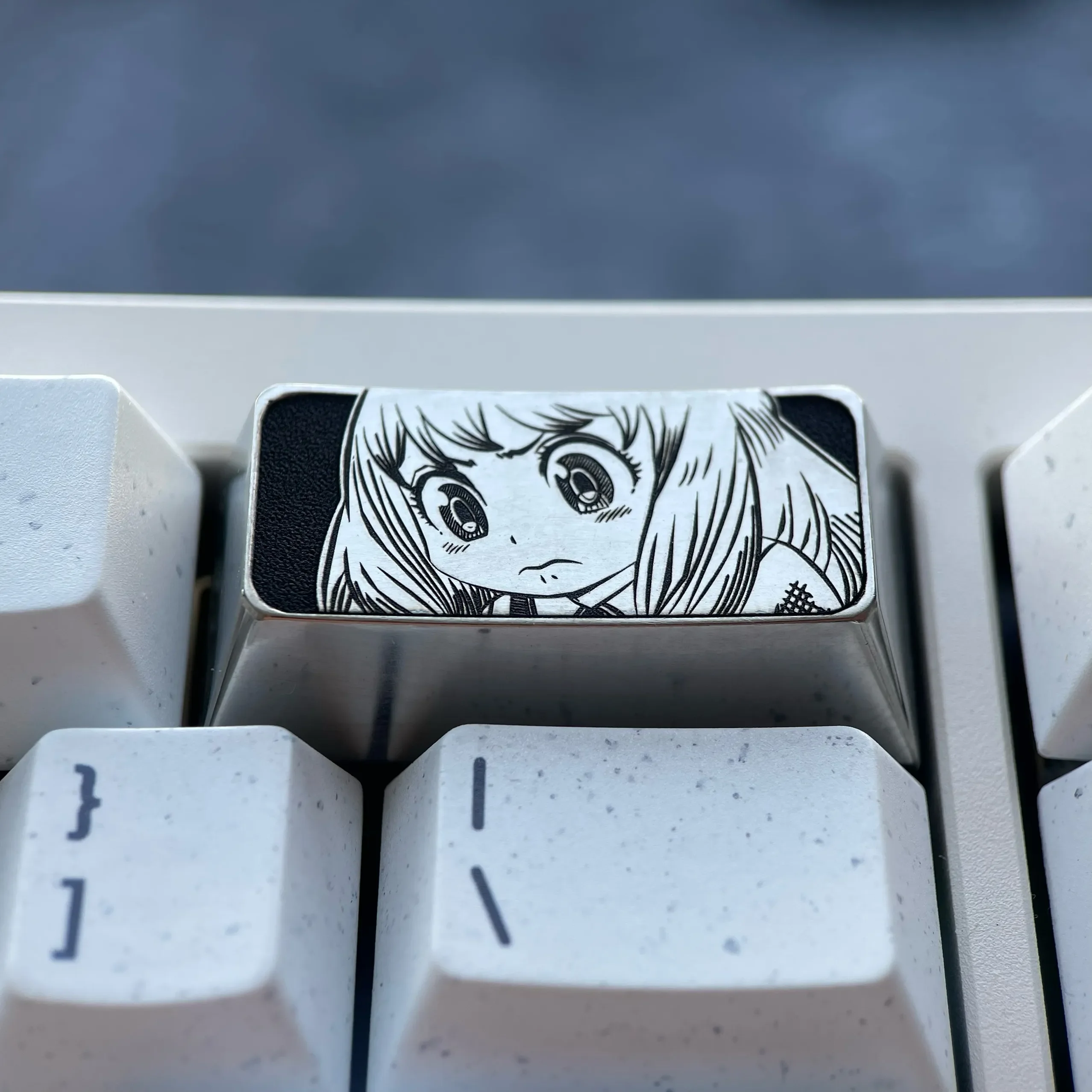 Anya Titanium Keycap, a premium engraved 2U backspace key for Spy x Family keyboards, showcasing its iconic Anya Forger design and sophisticated design.