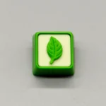 Exquisite handcrafted resin leaf artisan keycap showcasing delicate green leaves elegantly suspended in clear, nature-inspired resin, perfect for your keyboard.