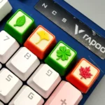 Handcrafted Resin Leaf Artisan Keycap showcasing delicate green leaves elegantly suspended in clear resin, highlighting its artistic beauty.