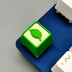 Gallery of the Handmade Resin Leaf Artisan Keycap. Delicate green leaves in clear resin, all angles, highlighting its serene, nature-inspired.