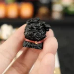 Whimsical black puppy artisan keycap, intricately handcrafted from resin, showcasing its playful design from multiple angles for mechanical keyboards.