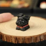 Delightful handcrafted resin black puppy artisan keycap, captured mid-play with a whimsical gust of wind detail.