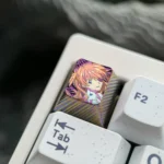 Exquisite hand-carved titanium Asuka keycap for Evangelion fans, showcasing intricate artisan detail and a premium metallic finish.