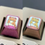 Vibrant pink anodized titanium Asuka ESC keycap for mechanical keyboards, showcasing iconic character design as a premium centerpiece.