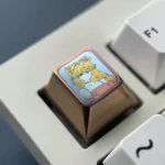 Gallery views of the premium pink anodized titanium Asuka ESC keycap, a bold centerpiece showcasing vibrant color and iconic design.