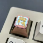 Iconic Asuka ESC keycap crafted from premium pink anodized titanium, offering a vibrant, artistic centerpiece for mechanical keyboards.