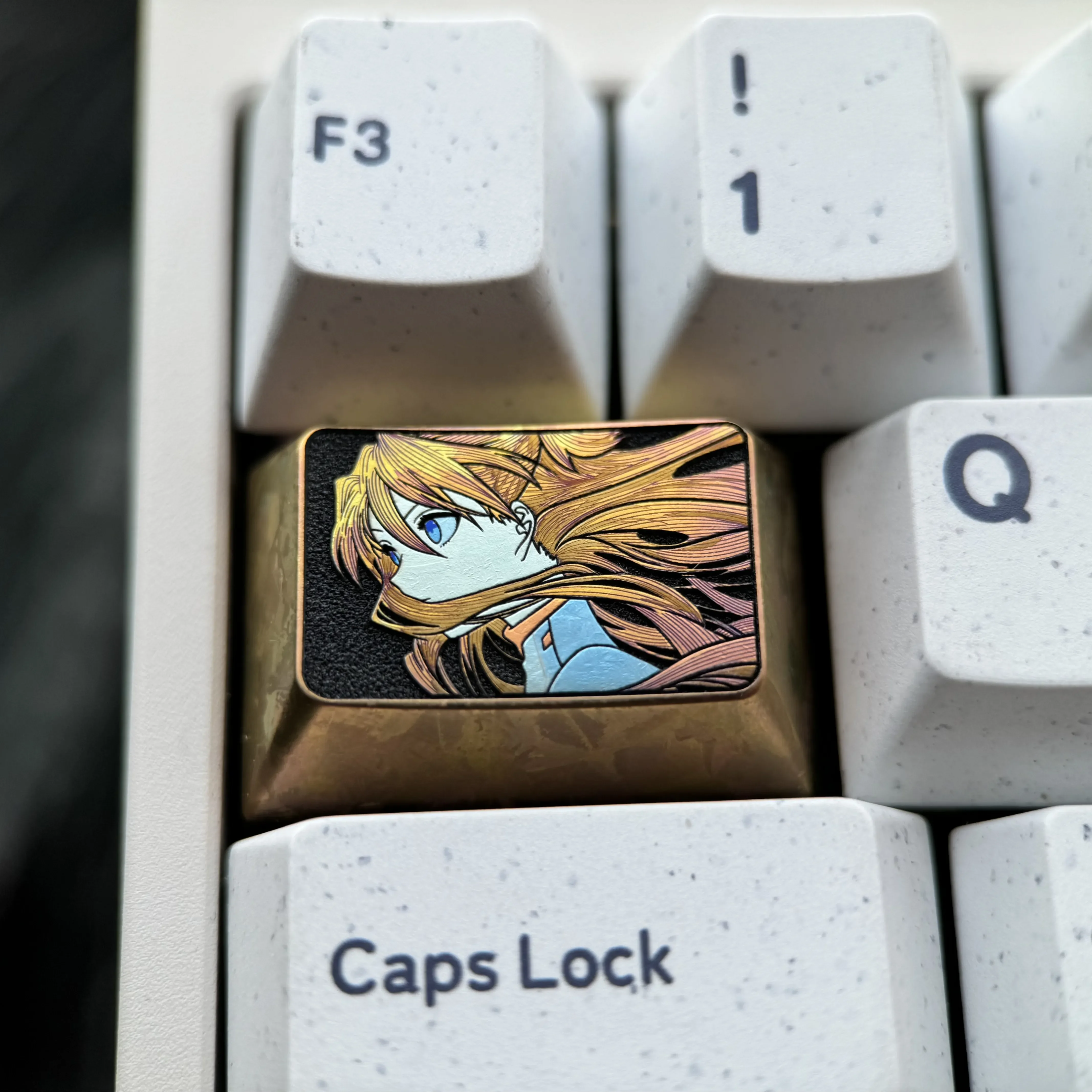 Precision-crafted Asuka titanium keycap main image, highlighting iconic fine-line art and vibrant premium titanium finish.