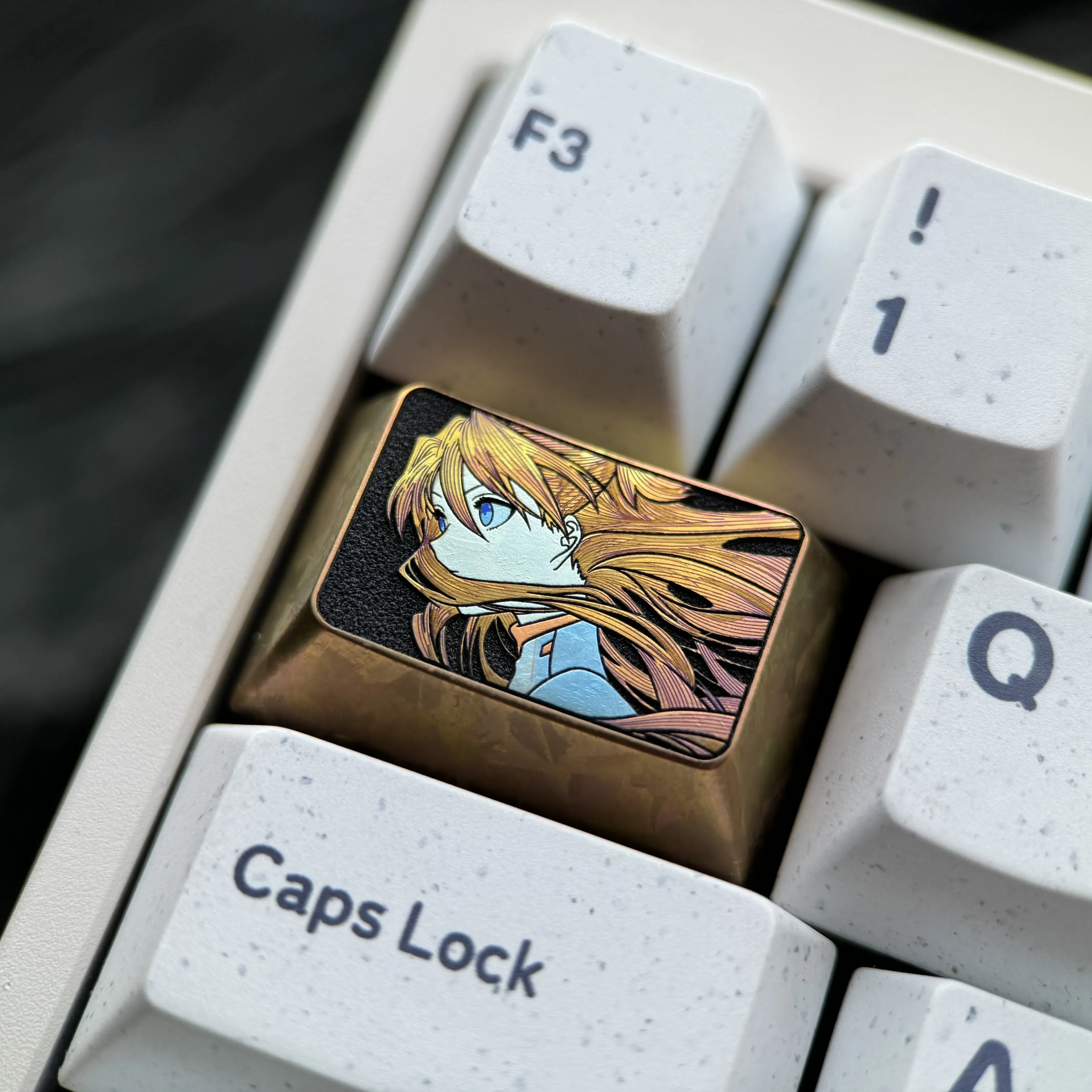 Detailed views of the premium Asuka titanium keycap. Showcasing iconic fine-line art and vibrant finish, reflecting its precision craftsmanship.