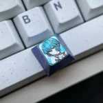 Close-up views of the exquisite Titanium Rei Ayanami keycap, showcasing its icy crystal blue design and intricate EVA tribute artwork.