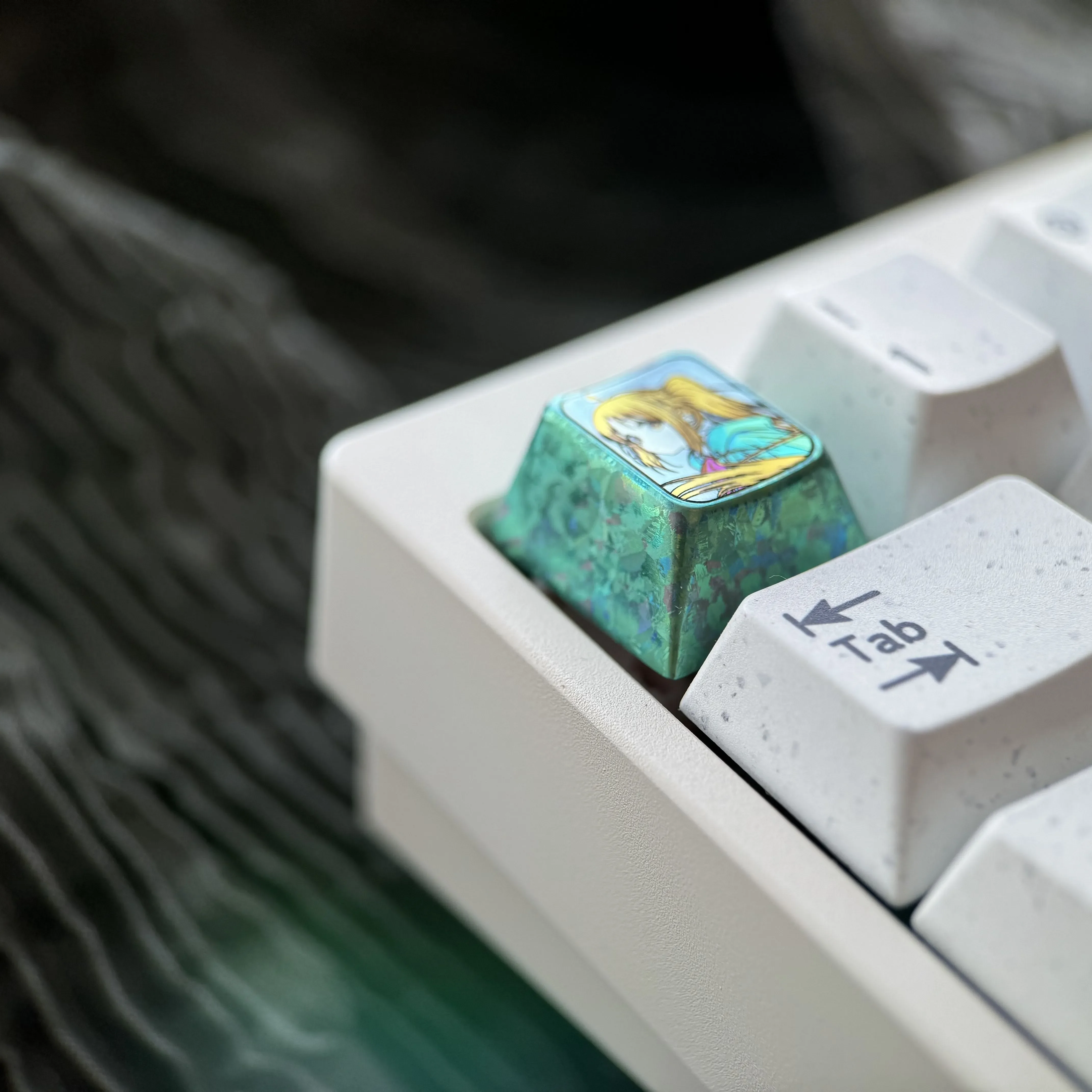 Gallery of the exclusive Bocchi the Rock Titanium Keycap, showcasing its uniuqe anime character art and premium ice crystal green titanium finish.