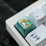 A gallery of the exclusive Bocchi the Rock Titanium Keycap, showcasing its vibrant anime character art and premium ice crystal green finish from the setup.