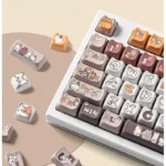 Playful calico cat keycaps set from different angles, showcasing vibrant PBT dye-sub illustrations and MAO profile on a custom mechanical keyboard.