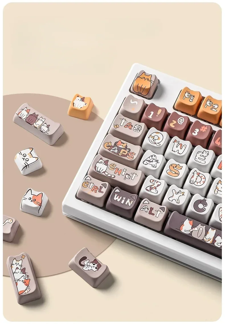 Playful calico cat keycaps set from different angles, showcasing vibrant PBT dye-sub illustrations and MAO profile on a custom mechanical keyboard.