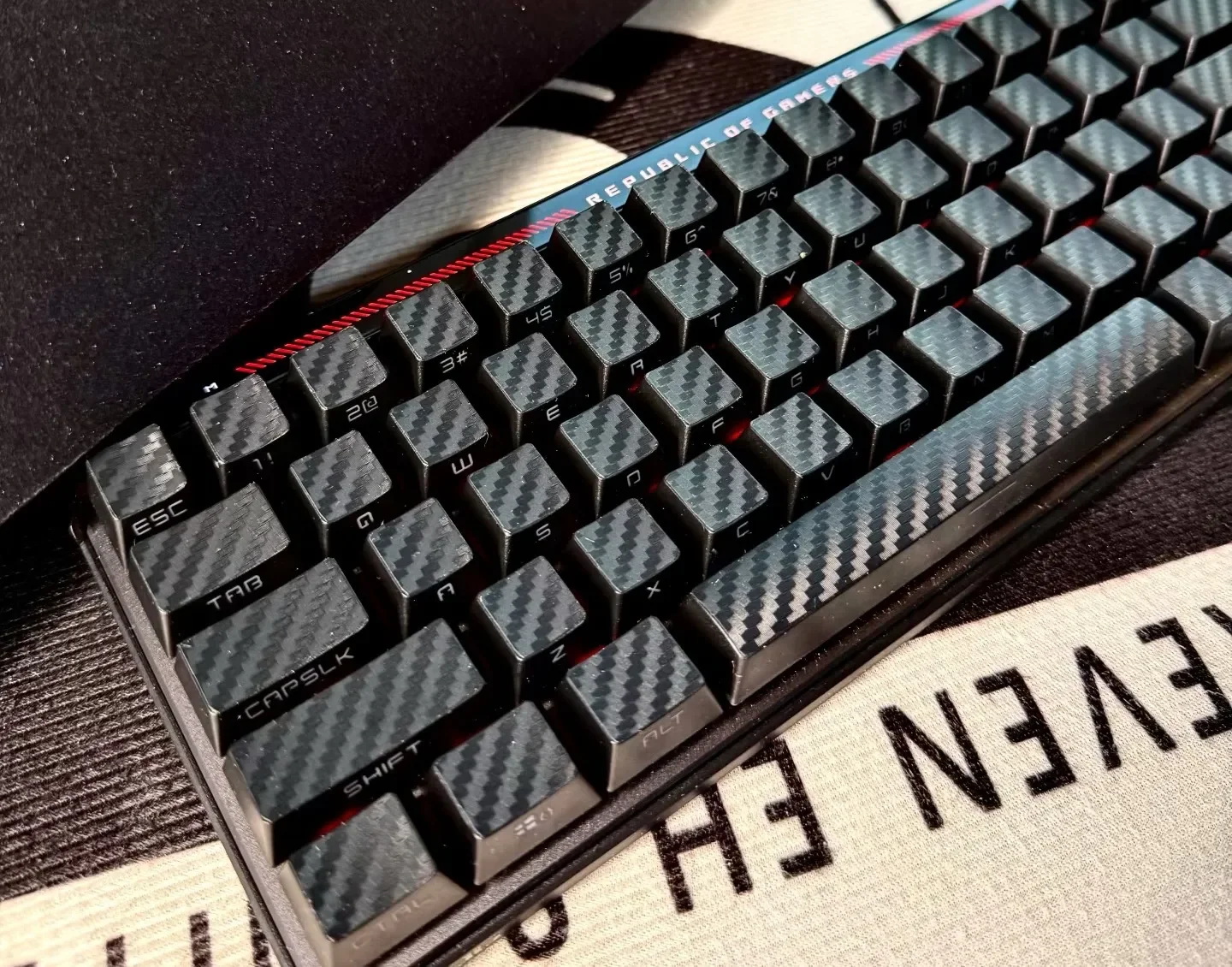 Premium forged black carbon fiber side-print keycap set displayed, highlighting their sleek matte texture, stealthy aesthetic, and durable design.