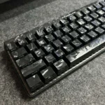 Premium forged black carbon fiber side-print keycap set showcasing their sleek matte texture and sophisticated design for mechanical keyboards.