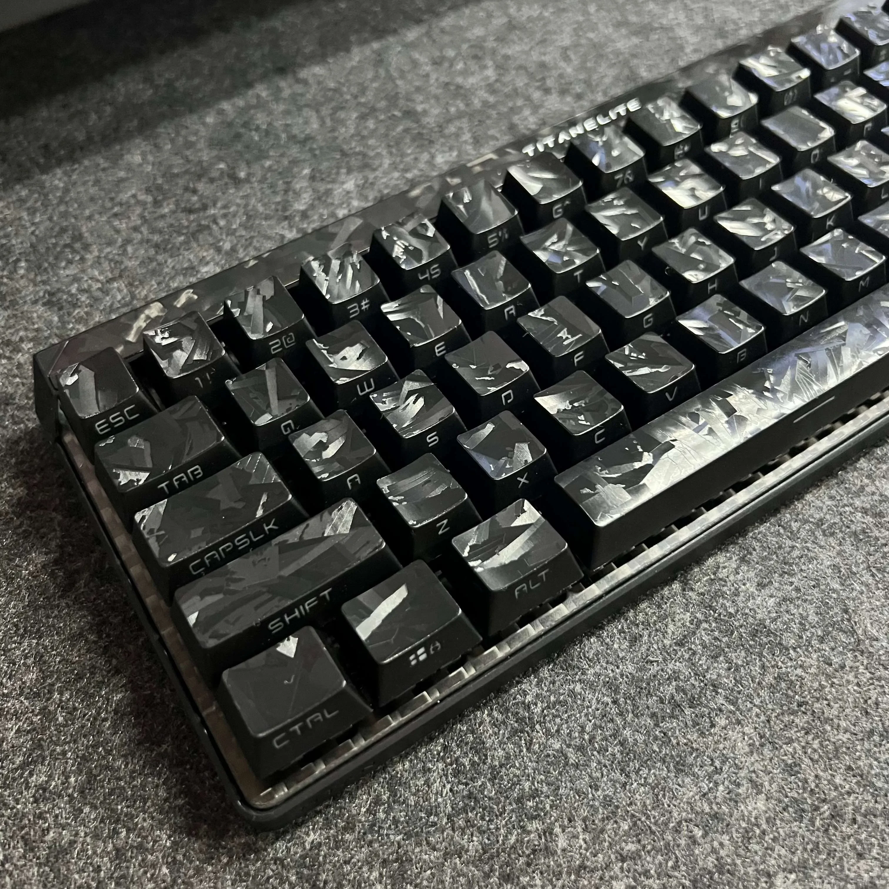 Premium forged black carbon fiber side-print keycap set showcasing their sleek matte texture and sophisticated design for mechanical keyboards.