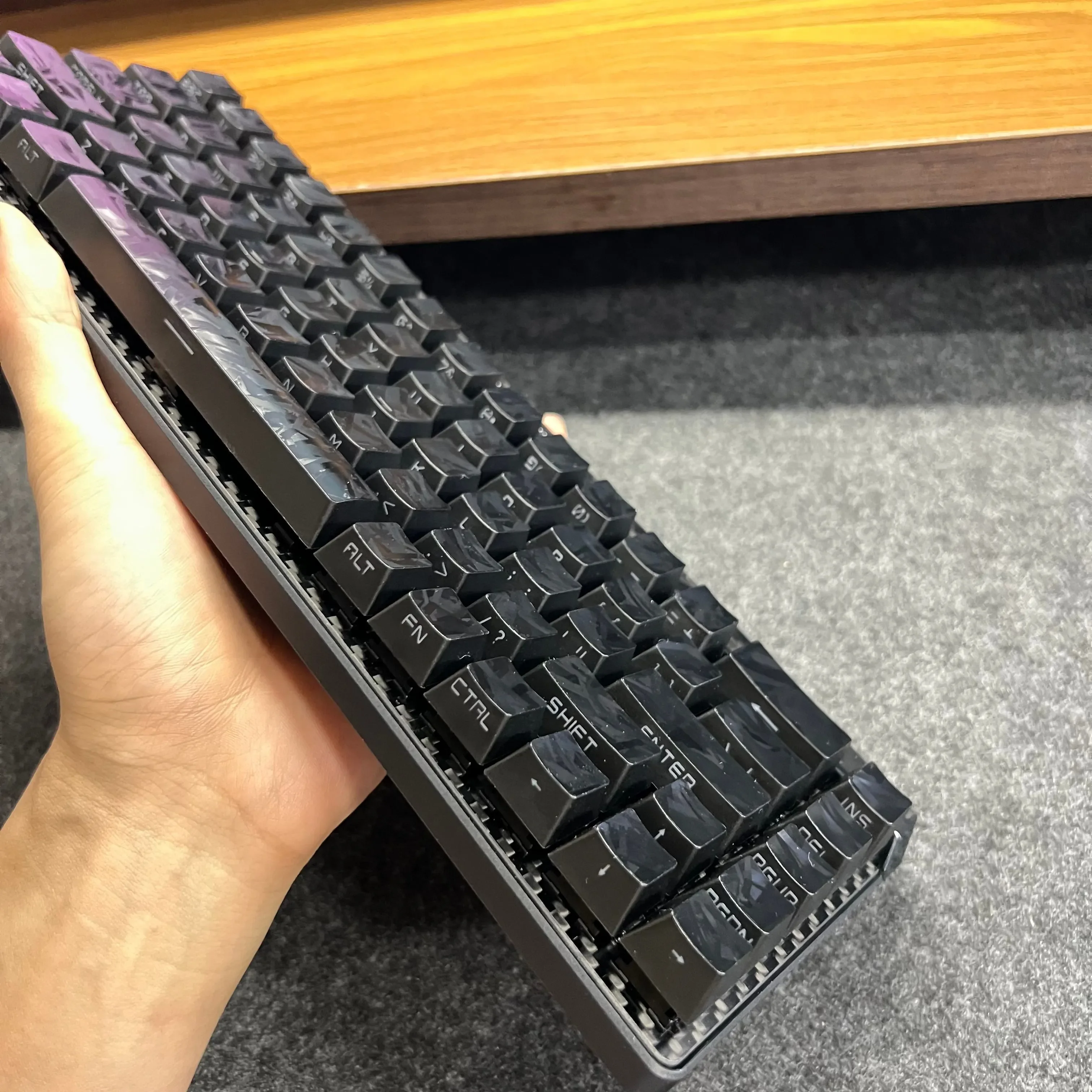 A gallery showcasing premium forged black carbon fiber side-print keycap set from multiple angles, highlighting their sleek matte texture.