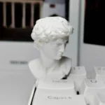 Handcrafted classical David sculpture artisan keycap. See the miniature bust's intricate details and artistic design from all angles.
