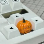Gallery views of the whimsical handcrafted Dungeon Meshi pumpkin keycap, showcasing its intricate artisan details and playful Halloween design.