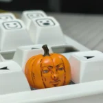 Whimsical handcrafted Dungeon Meshi pumpkin keycap from various angles, showcasing intricate artisan details and playful anime design.