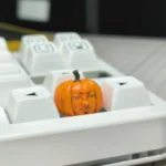 Multiple views of the whimsical handcrafted Dungeon Meshi pumpkin keycap, highlighting its intricate artisan details from all angles.