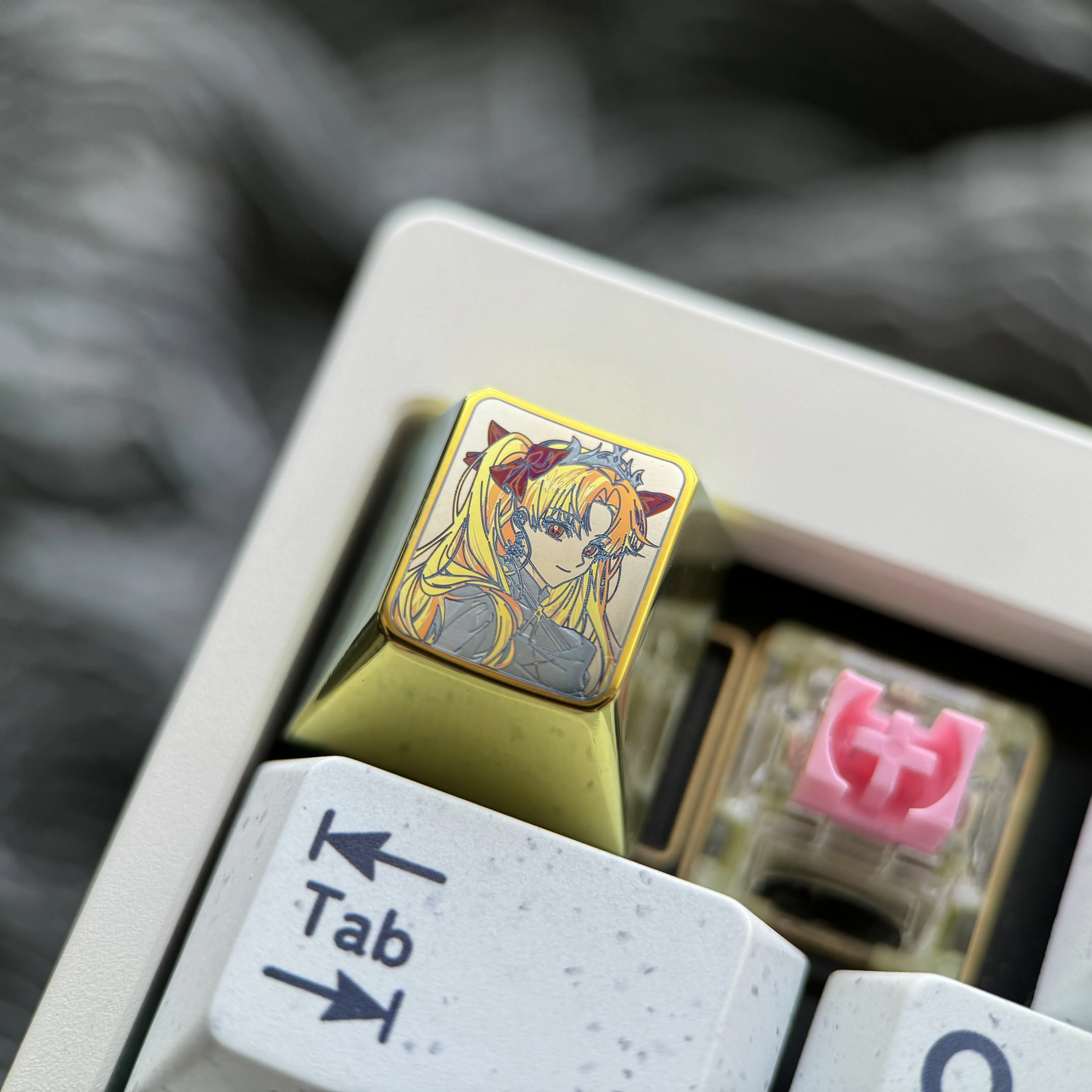 Diverse views of the premium Ereshkigal titanium alloy keycap, showcasing its intricate anime design and vibrant iridescent finish.