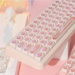 A gallery view of the Ethereal Pink Keycap Set, showcasing the mystical shifting cat's eye luminescence from various angles.