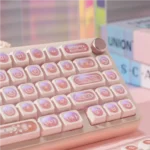 Ethereal Pink Keycap Set gallery. Luminous PBT Cat's Eye effect, varied angles. Shifting pink light like mystical gemstones.