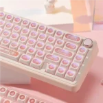 Ethereal pink keycap set shimmering with a luminous, shifting cat's eye effect, evoking mystical gemstones for a dreamy keyboard aesthetic.