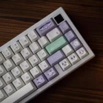 Ethereal Frieren keycap set displayed from multiple angles, showcasing intricate dye-sublimated designs and cool-toned PBT magic motifs for custom purpose.