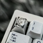 Hand-sculpted Titanium Frieren keycap with precision-carved portrait and intricate stippling on mirror-finish titanium.