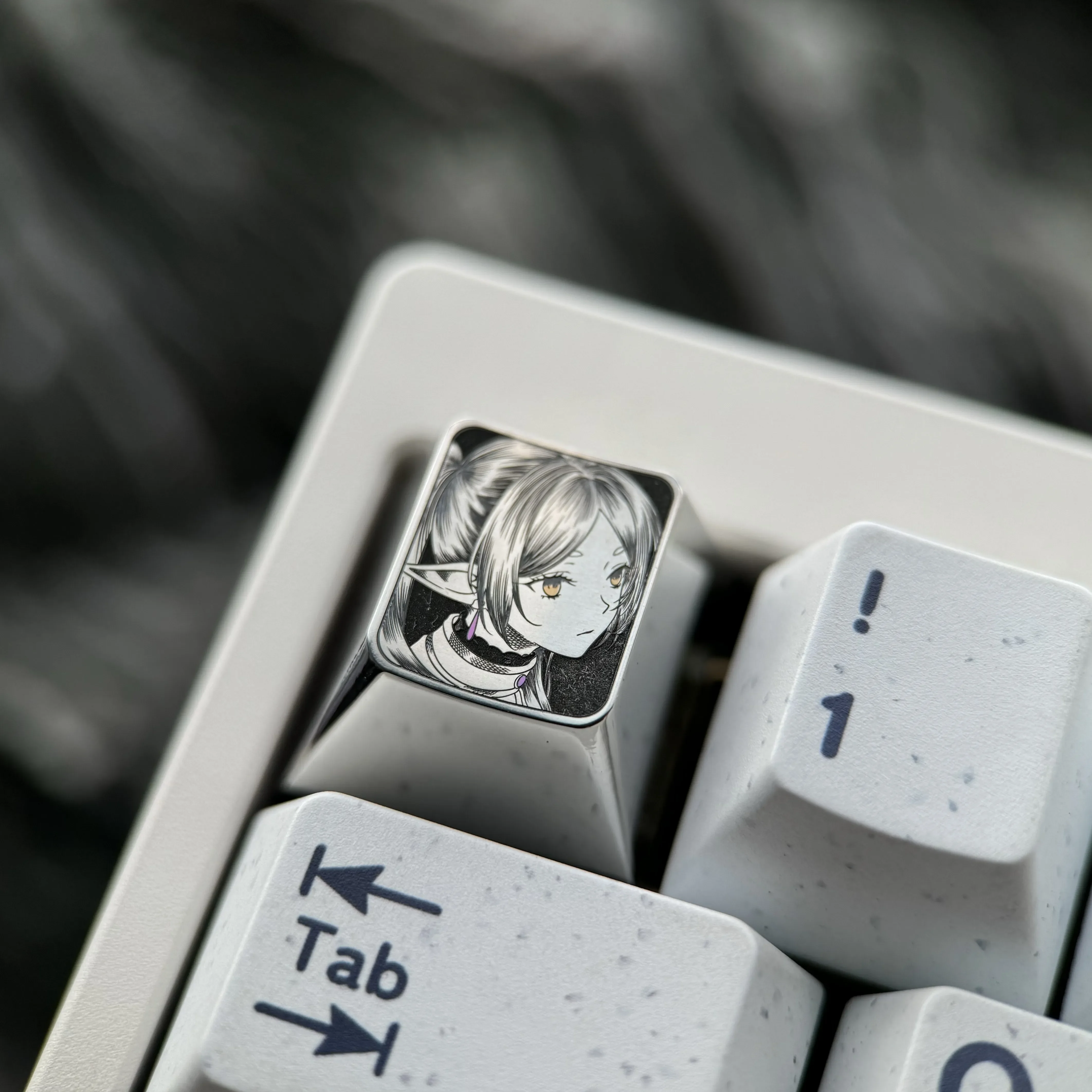 Hand-sculpted Titanium Frieren keycap with precision-carved portrait and intricate stippling on mirror-finish titanium.