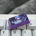A colorful titanium alloy 2U backspace keycap features a personalized Raiden Shogun design, perfect for custom mechanical keyboards.