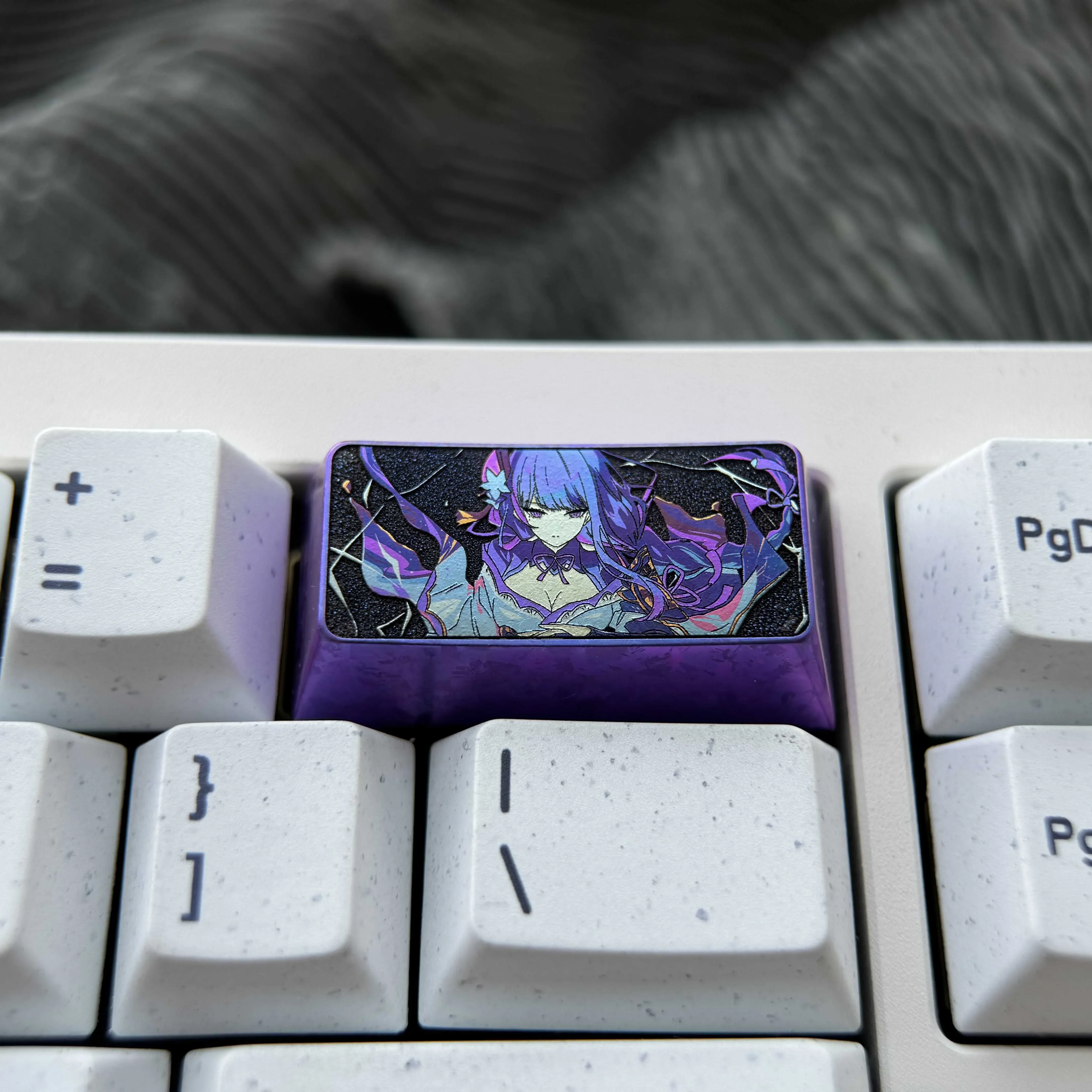 Custom-crafted titanium alloy 2U backspace keycap features the iconic Raiden Shogun from Genshin Impact for unique keyboard personalization.