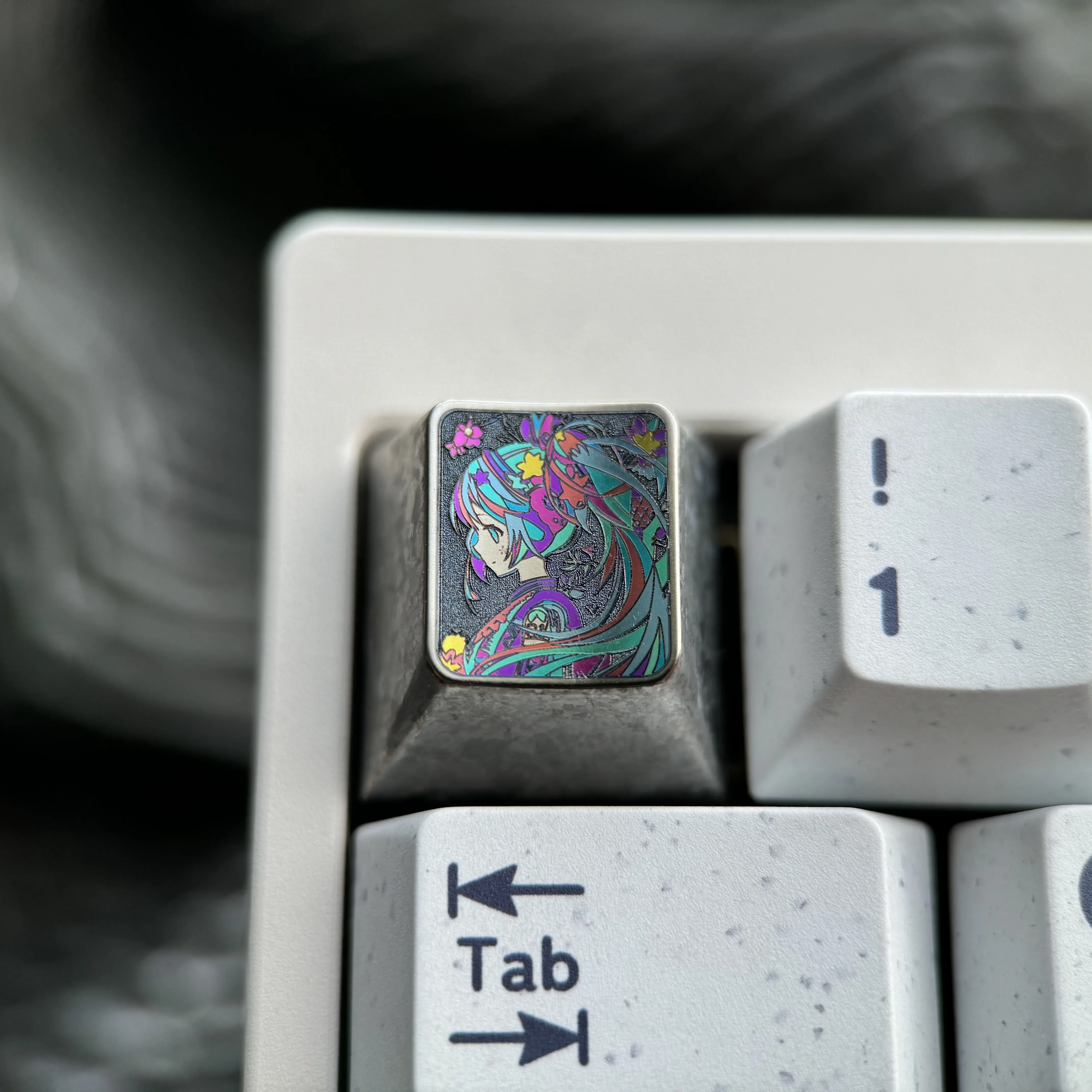 Exclusive Hatsune Miku titanium alloy ESC keycap in shimmering ice crystal silver, a sleek metallic tribute for mechanical keyboards.