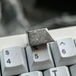 Exclusive Hatsune Miku Titanium Alloy ESC keycap showcasing its shimmering Ice Crystal Silver finish and sleek metallic design for mechanical keyboard.