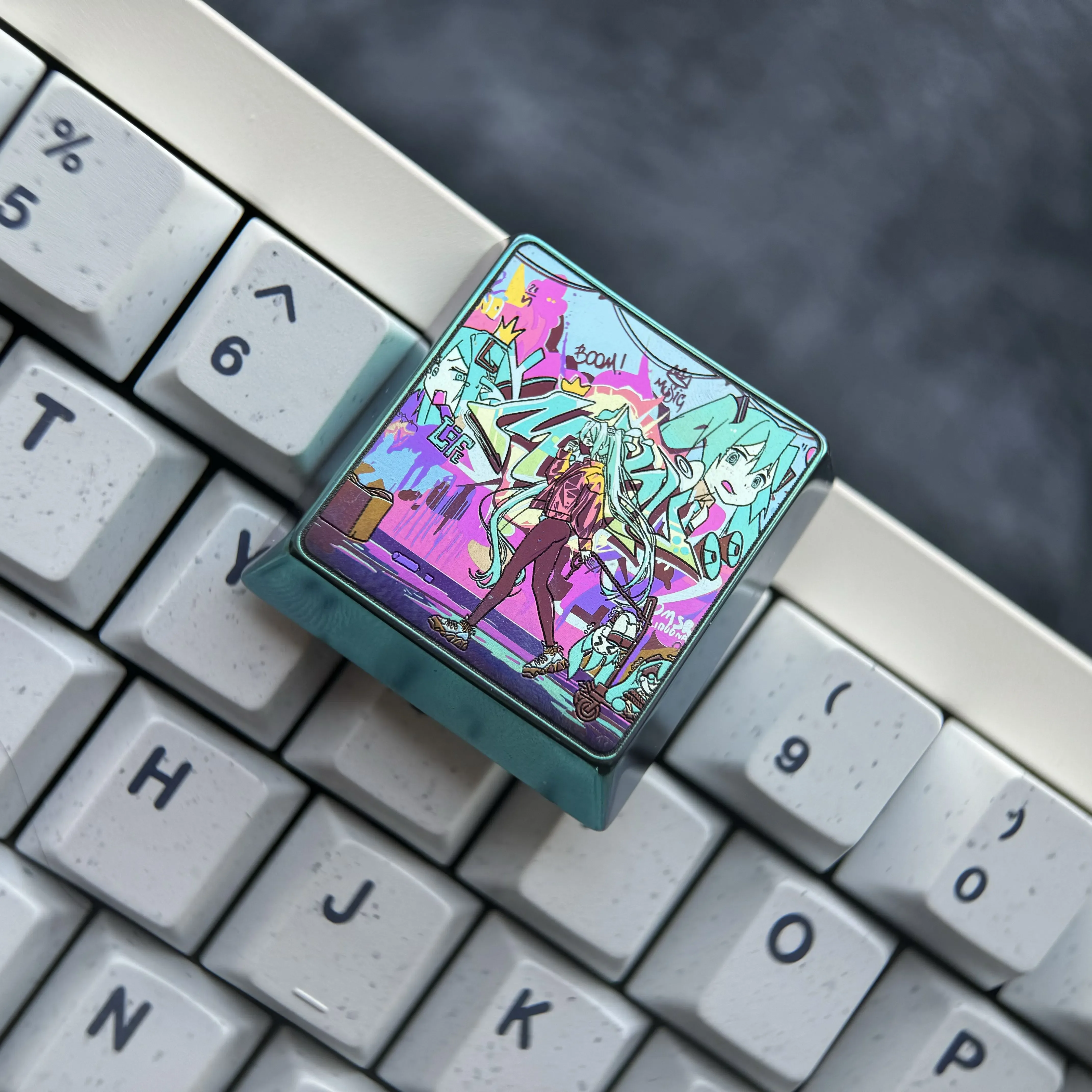 Iconic Hatsune Miku keycap crafted from premium iridescent titanium alloy, artfully displayed from various angles, highlighting its vibrant finish.