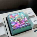 Experience the iconic Hatsune Miku premium titanium alloy keycap from multiple angles, revealing its vibrant anime art and iridescent futuristic design.