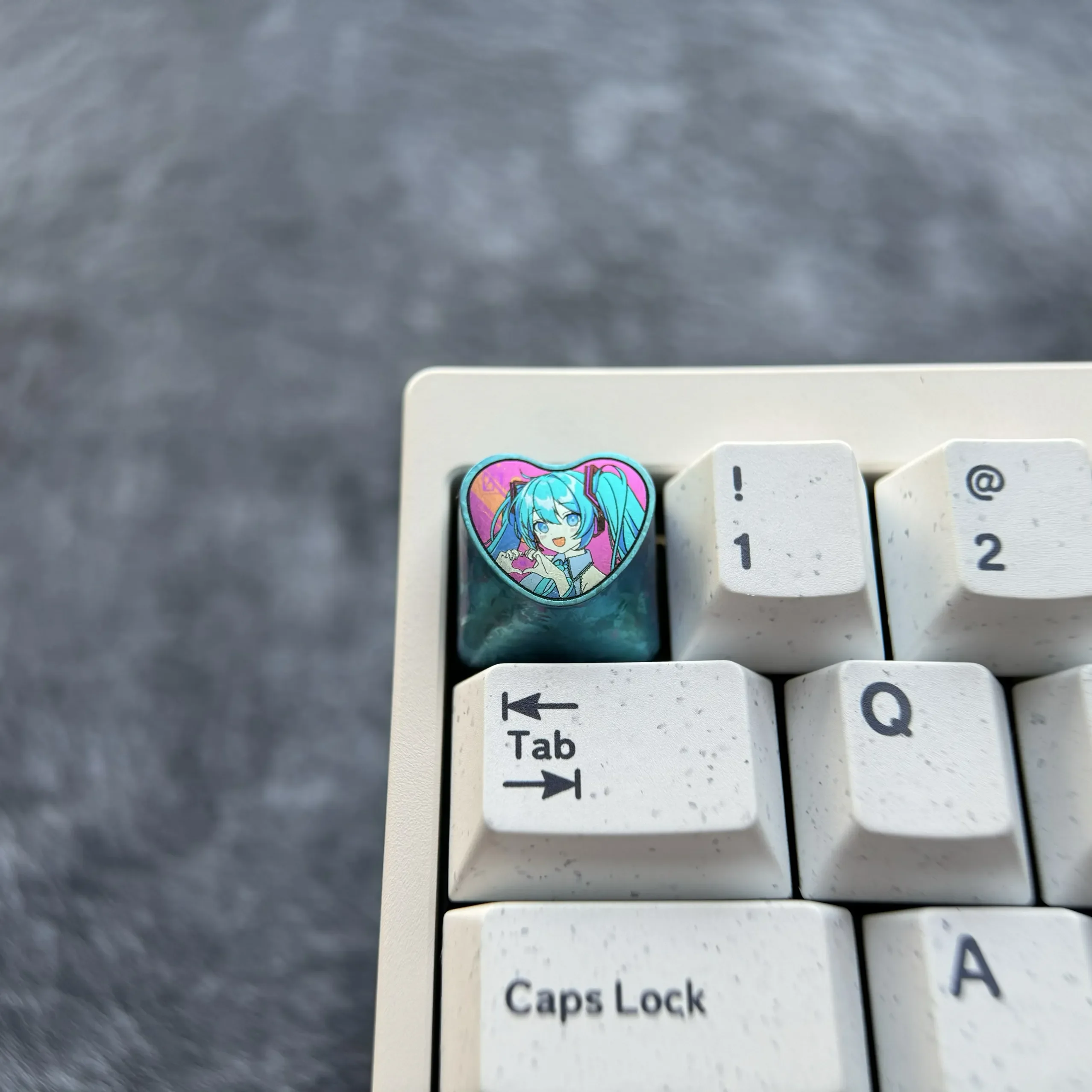 Explore the Official Hatsune Miku Titanium Artisan Keycap from various perspectives, revealing its vibrant heart design, polished titanium finish setup.