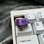 Gallery showcasing the premium Herta Ice Crystal Purple Anodized Titanium ESC Keycap, revealing its luminous celestial finish from various angles.